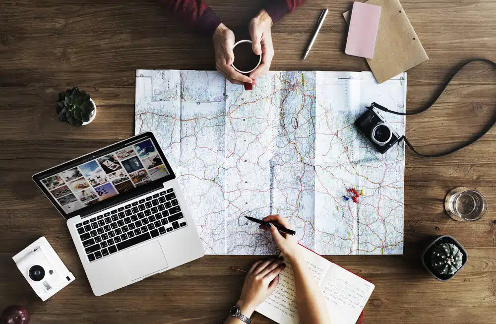 Business professionals engaged in adventure activities like mountain climbing, team challenges, and outdoor leadership experiences
